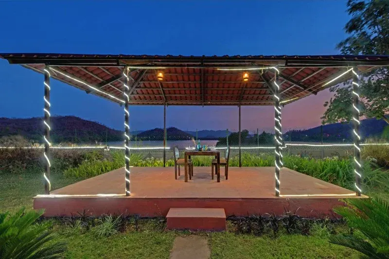 Outdoor dining tables beside a Tent City cottage
